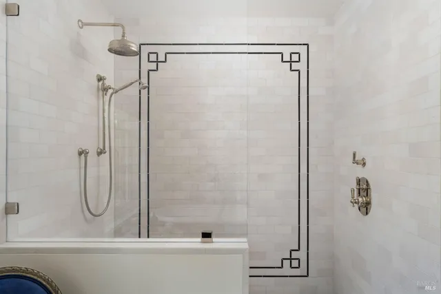 a bathroom with a shower and a shower