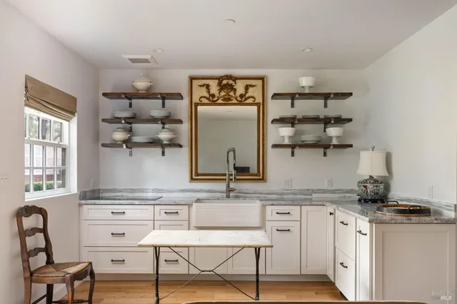 a kitchen with stainless steel appliances granite countertop a stove and cabinets