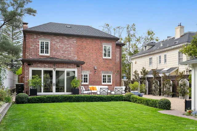 a front view of a house with a garden and plants