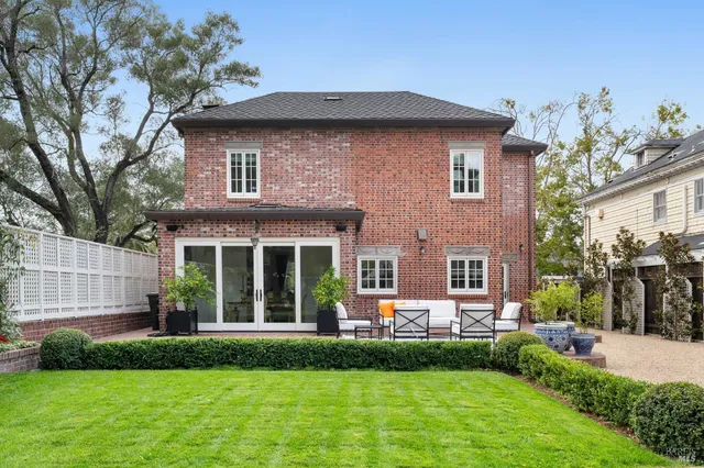 a front view of a house with sitting area and garden