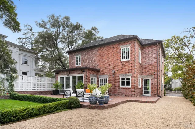 a view of a patio with a fireplace and potted plants