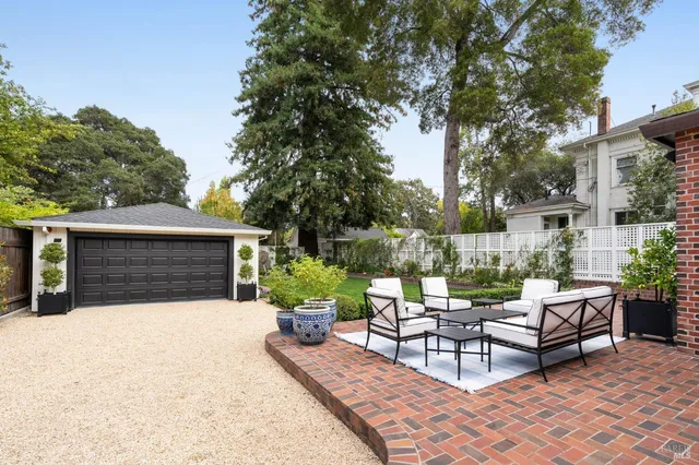 a view of a house with backyard and sitting area