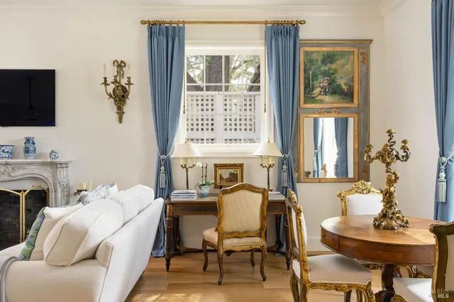 a living room with furniture fireplace and a flat screen tv