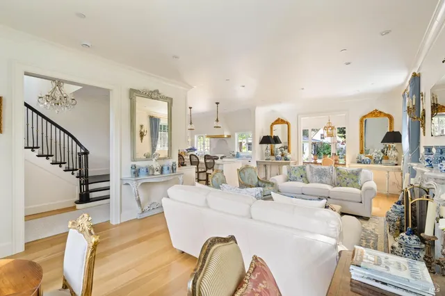 a living room with furniture fireplace and wooden floor