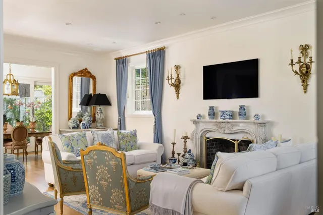 a living room with furniture a fireplace and a flat screen tv