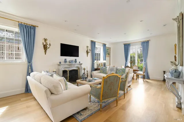 a living room with furniture a fireplace and a flat screen tv