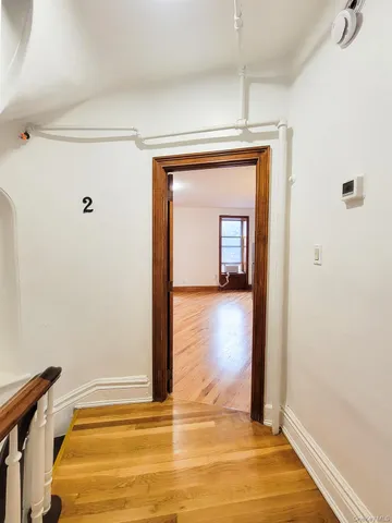 a view of a room with wooden floor and a ceiling fan