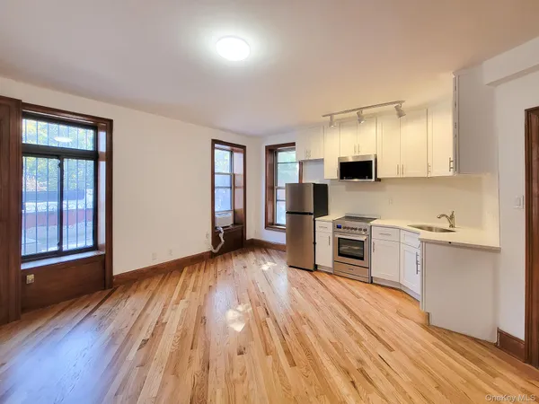 a kitchen with a refrigerator and a stove top oven