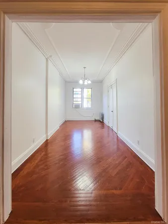 a view of room with window and wooden floor