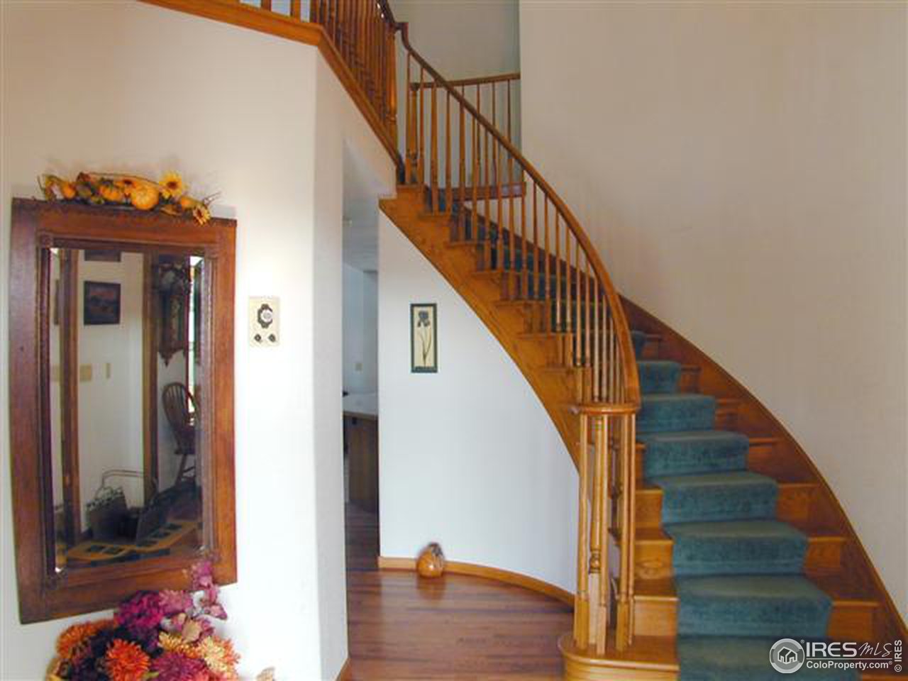 7090 Spring Glade Road Loveland, CO 80538 - Photo 11 of 18 a view of entryway and hall with wooden floor