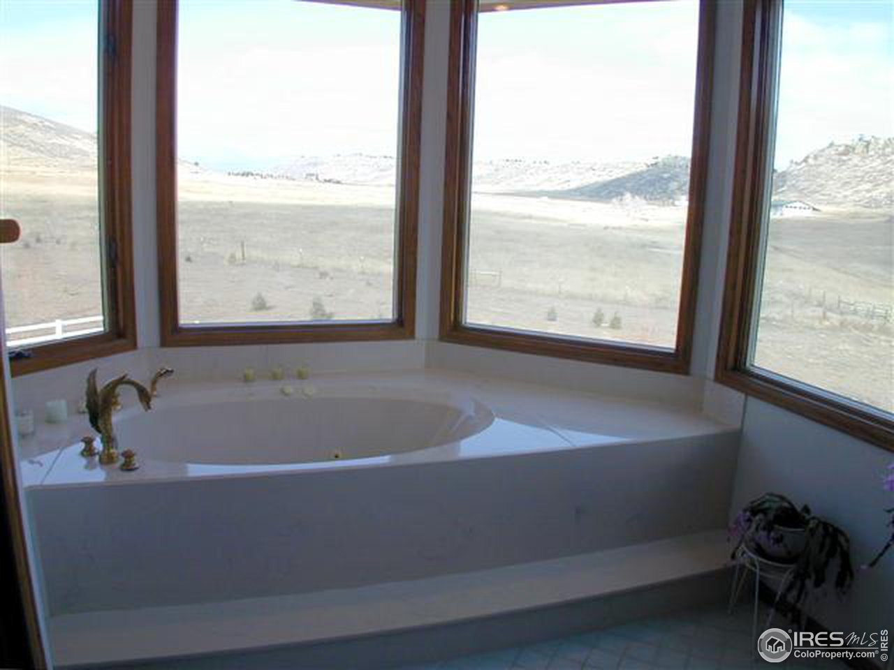 7090 Spring Glade Road Loveland, CO 80538 - Photo 13 of 18 a white bath tub sitting next to a window