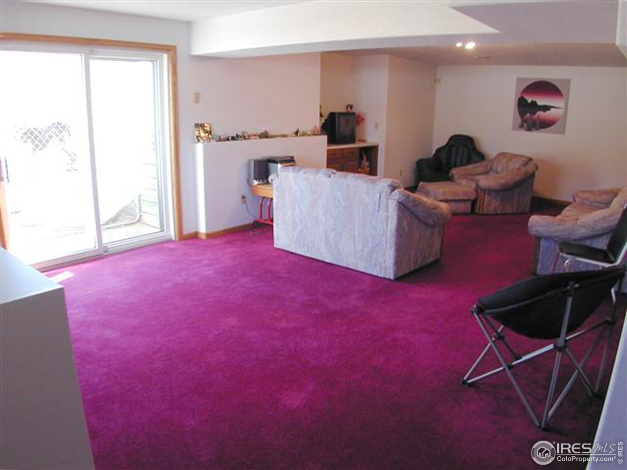 7090 Spring Glade Road Loveland, CO 80538 - Photo 15 of 18 a living room with furniture and a flat screen tv