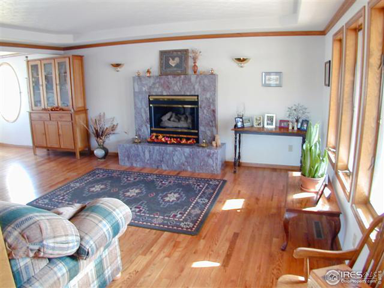 7090 Spring Glade Road Loveland, CO 80538 - Photo 10 of 18 a living room with furniture and a fireplace