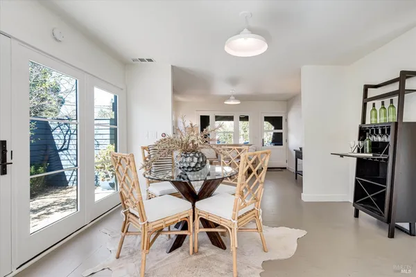 a view of a dining room with furniture and a window