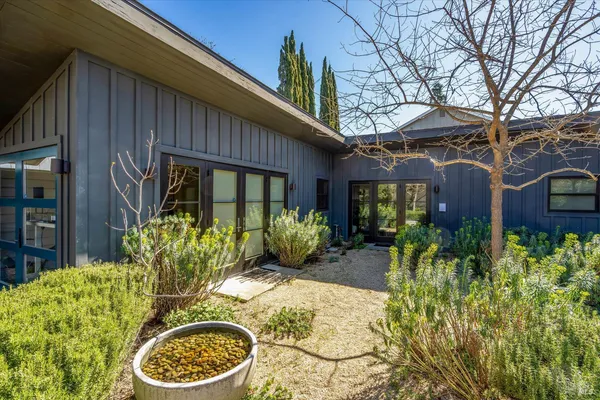 a view of a house with backyard and sitting area