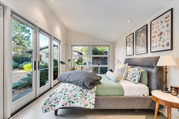 a bedroom with furniture and large window