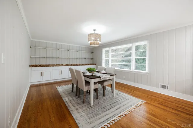 a kitchen with white cabinets and sink