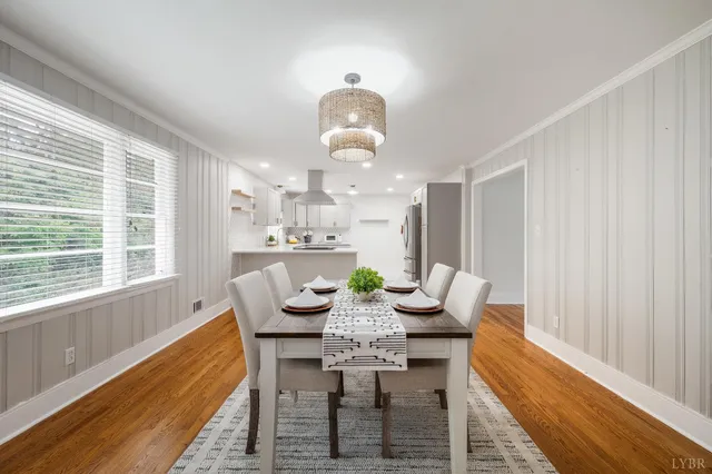 a kitchen with stainless steel appliances granite countertop a sink a stove and a wooden cabinets