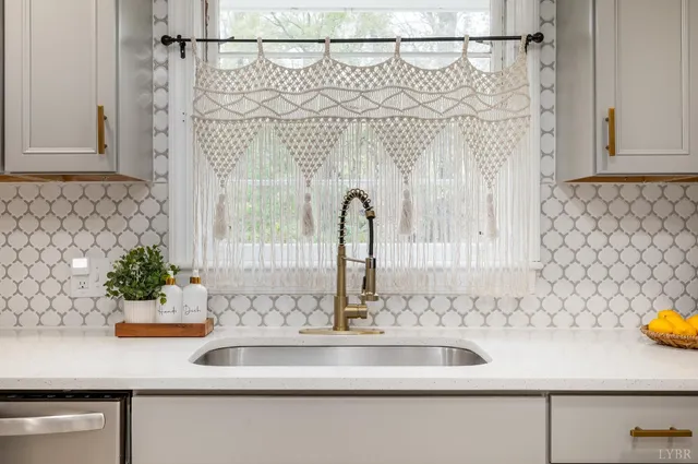 a kitchen with a refrigerator and a stove top oven