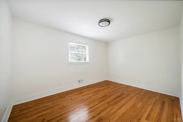 a empty room with furniture and window