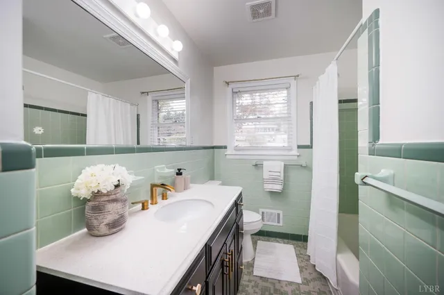 a view of a big room with wooden floor and windows