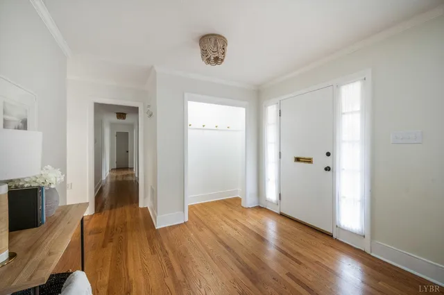 a view of a livingroom with wooden floor and a kitchen space