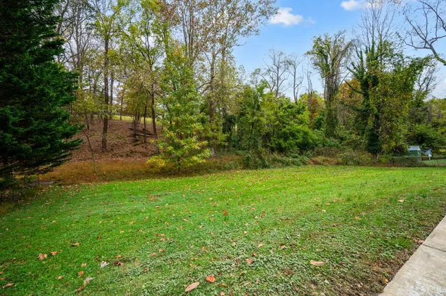 a backyard of a house with table and chairs