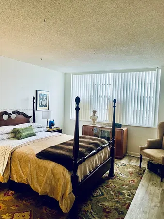 a living room with furniture a flat screen tv and a large window