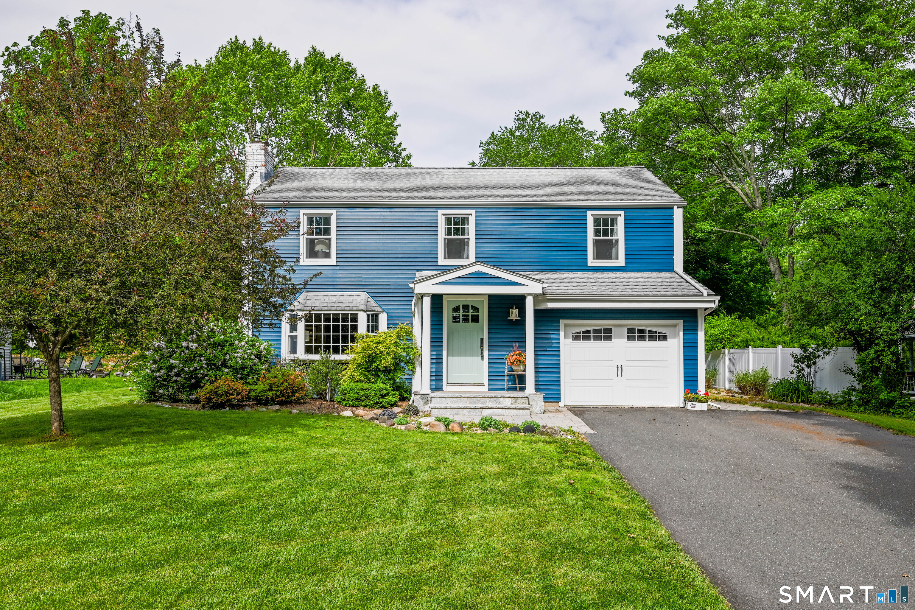 47 Spring Lane West Hartford, CT 06107 - Photo 1 of 38 a front view of a house with garden