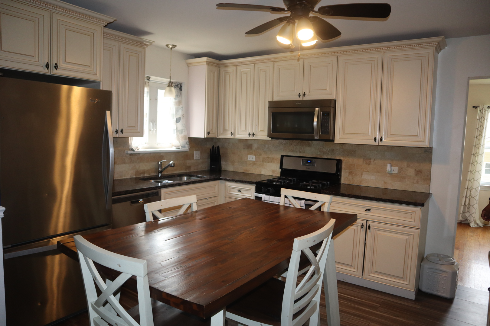 3218 Cuyler Avenue Berwyn, IL 60402 - Photo 5 of 17 a kitchen with a table chairs microwave and refrigerator