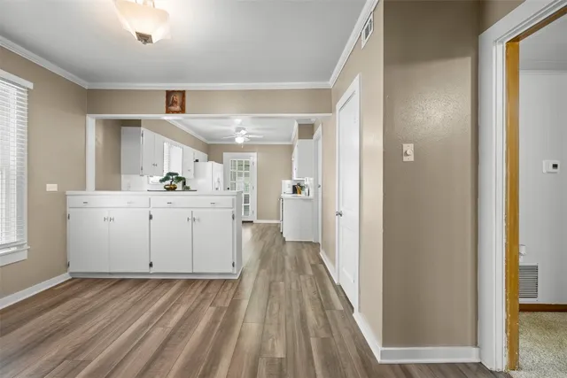 a view of a kitchen with a sink and wooden floor