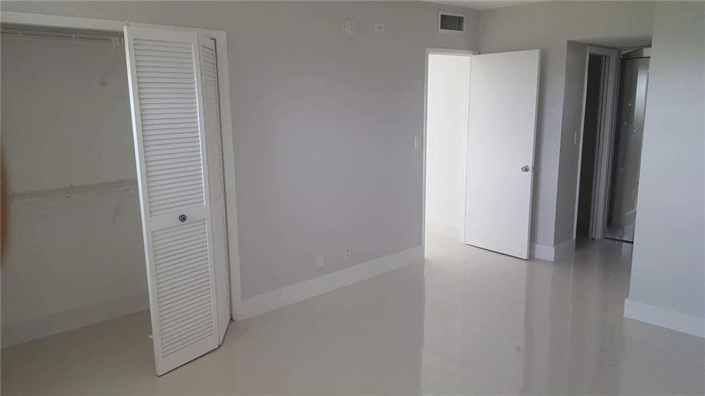 3150 North Course Lane, Unit 607 Pompano Beach, FL 33069 - Photo 8 of 16 a view of a hallway with closet