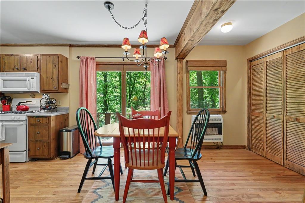102 Moses Road Rabun Gap, GA 30568 - Photo 11 of 40 a view of a dining room with furniture window and outside view