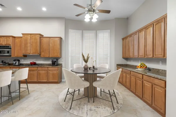 a kitchen with kitchen island granite countertop a sink counter top space appliances and cabinets