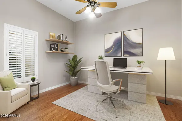 a view of wooden floor and a chandelier fan in a room