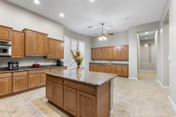 a bathroom with a granite countertop tub sink and mirror