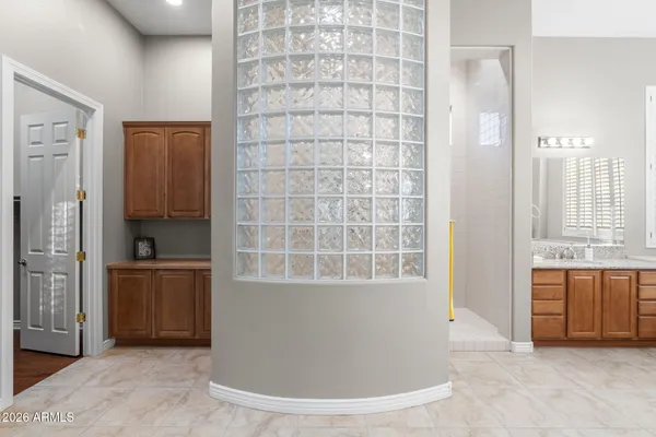 a bathroom with a granite countertop shower sink vanity and toilet