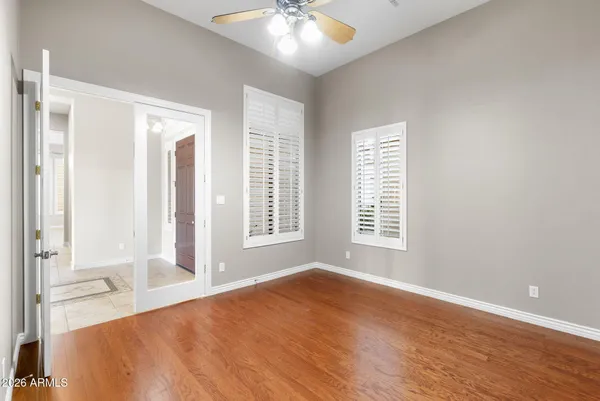 a view of a white house with a yard and large tree