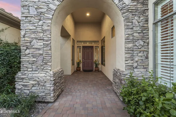 a kitchen with stainless steel appliances granite countertop a stove top oven a sink dishwasher and white cabinets with wooden floor