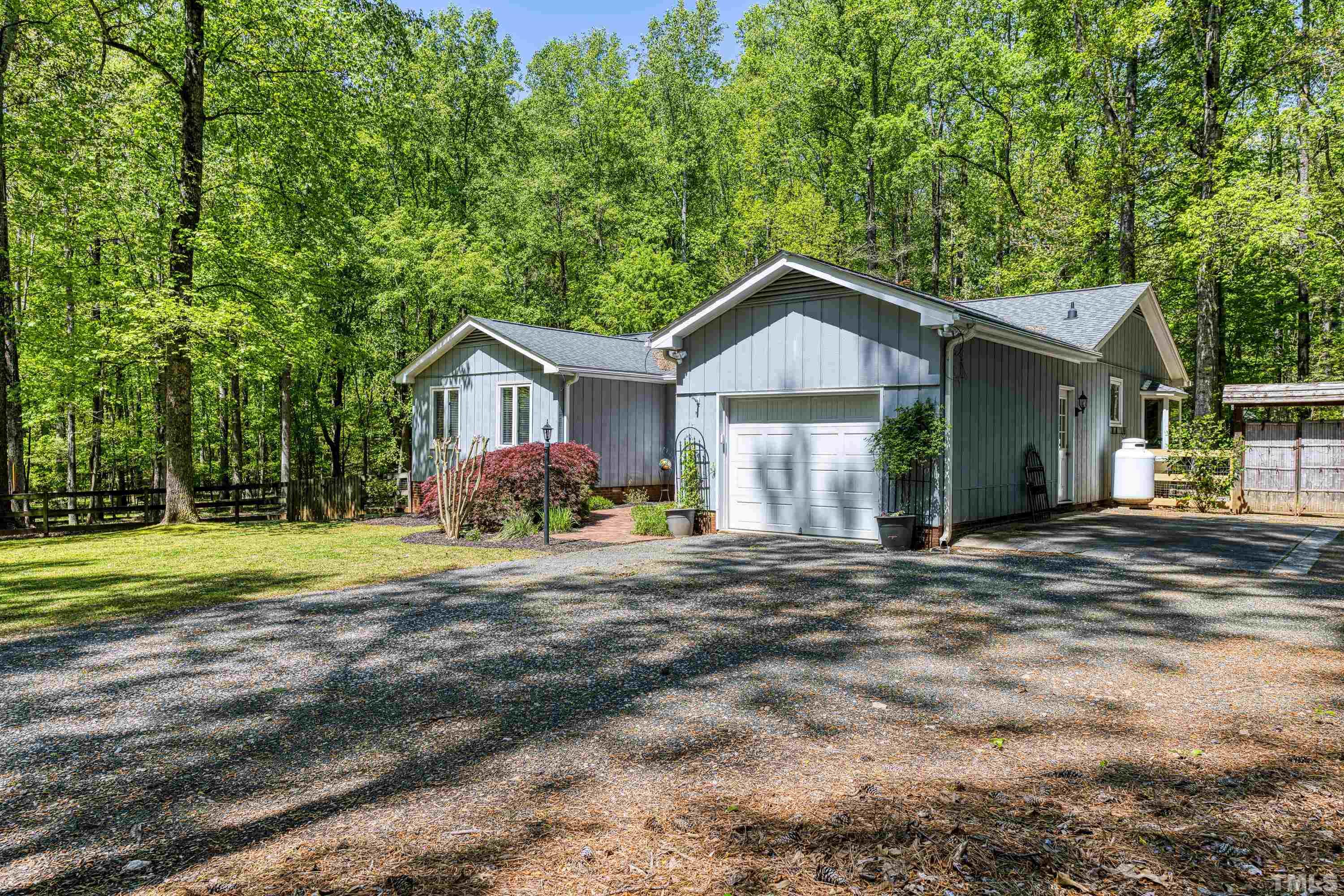 7311 Paddock Drive Raleigh, NC 27613 - Photo 3 of 43 a front view of a house with a yard and garage