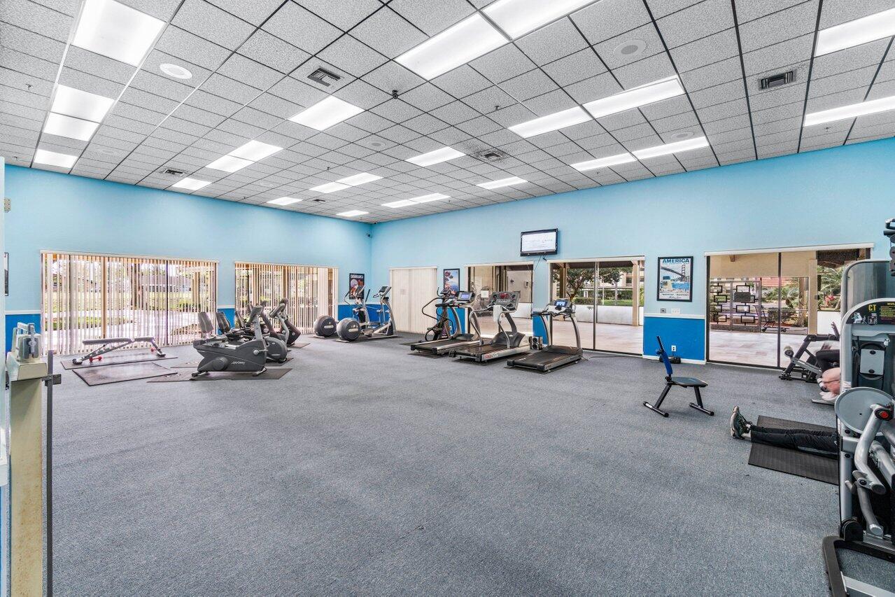 23345 Carolwood Lane, Unit 406 Boca Raton, FL 33428 - Photo 35 of 38 a view of a room with gym equipment