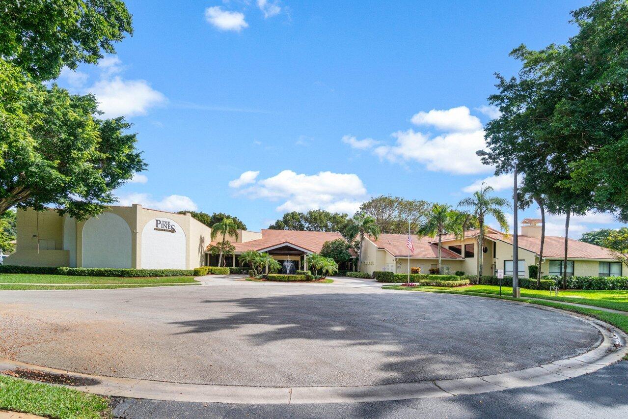 23345 Carolwood Lane, Unit 406 Boca Raton, FL 33428 - Photo 37 of 38 a view of a street with a houses