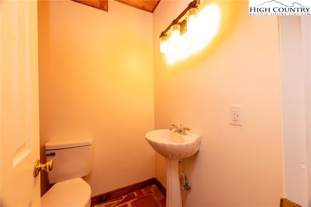 a view of a dining room with furniture and a chandelier