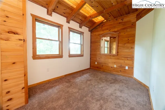 a view of a blue house with large windows