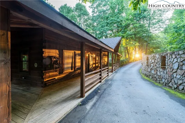 a backyard of a house with barbeque oven and trees