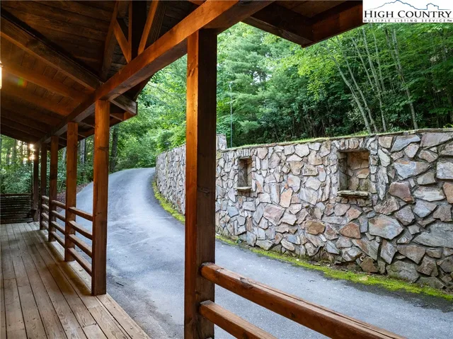 a view of a wooden deck next to a yard