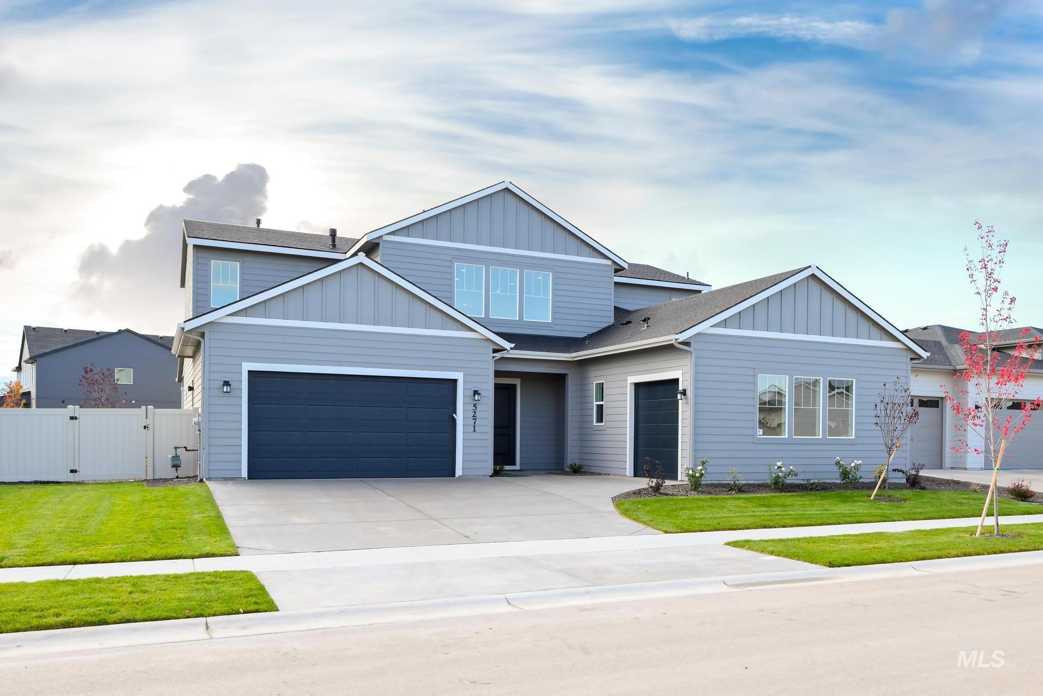 View of front facade with board and batten siding, a gate, driveway, and roof with shingles