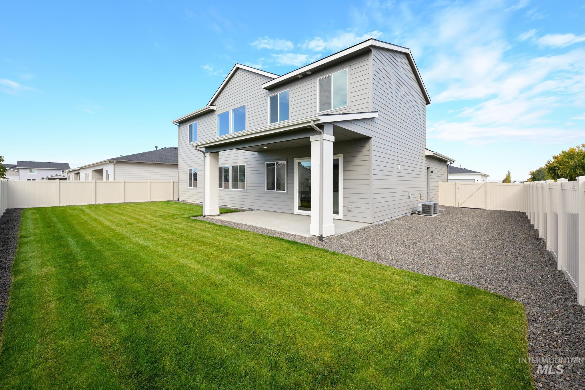 9044 West Purple Martin Street Star, ID 83669 - Photo 14 of 14 Back of property featuring a patio, a fenced backyard, and a gate
