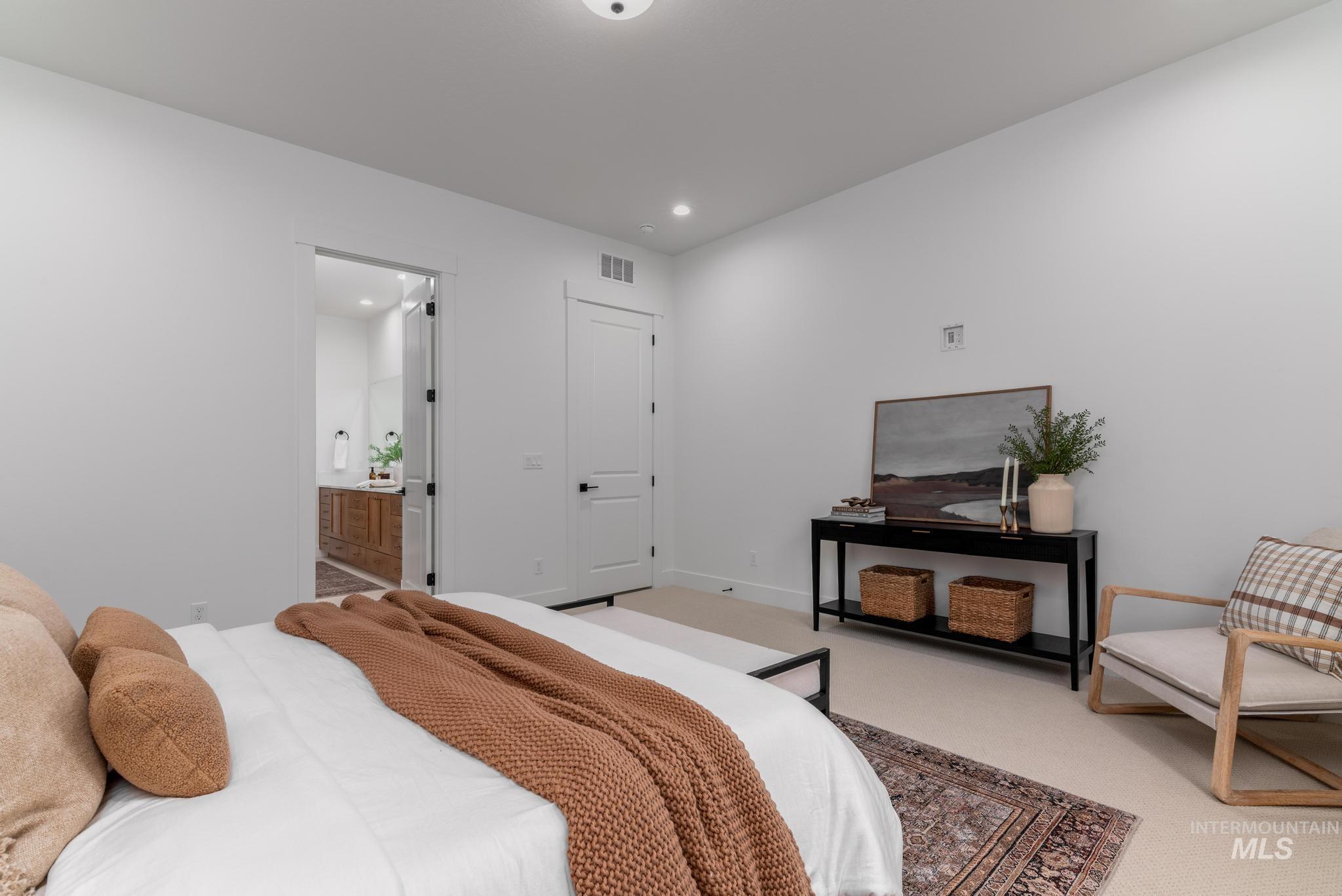 9044 West Purple Martin Street Star, ID 83669 - Photo 9 of 14 Carpeted bedroom with ensuite bathroom and baseboards