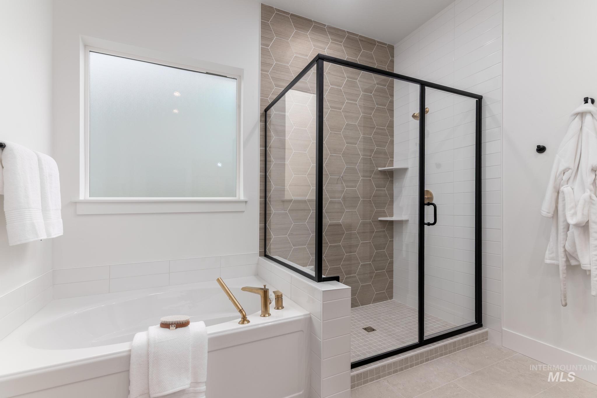 9044 West Purple Martin Street Star, ID 83669 - Photo 10 of 14 Bathroom with a bath, a stall shower, and light tile patterned floors